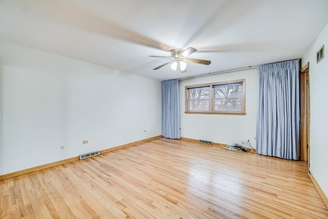 spare room with ceiling fan and light wood-type flooring