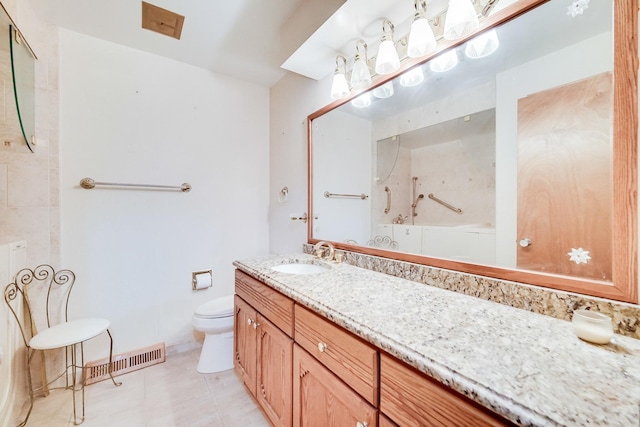 bathroom with vanity, toilet, and tile patterned flooring