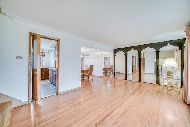 spare room with crown molding and light hardwood / wood-style floors