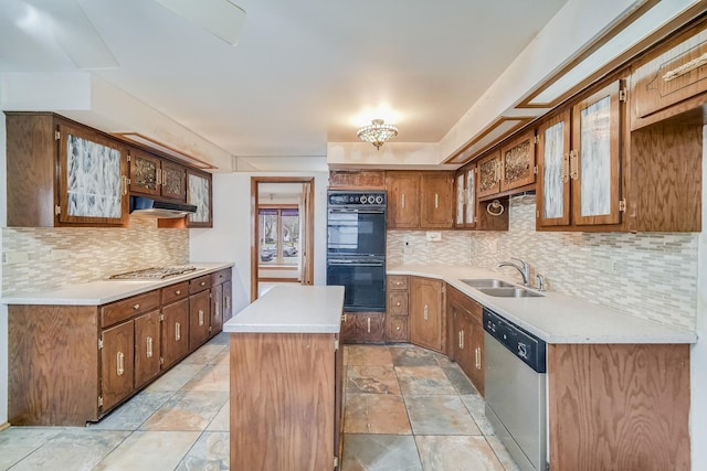 kitchen featuring sink, backsplash, a center island, and appliances with stainless steel finishes