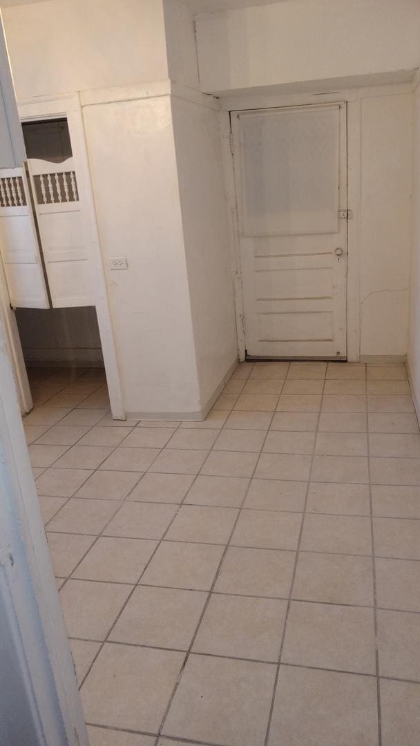 hallway with light tile patterned floors