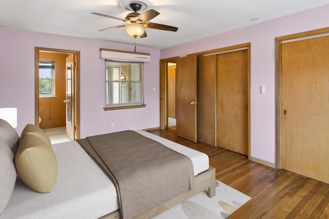 bedroom with light hardwood / wood-style flooring, ceiling fan, and ensuite bathroom