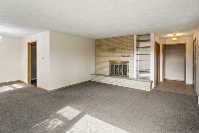 unfurnished living room with a fireplace, carpet floors, and a textured ceiling