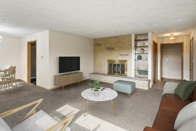 living room featuring a brick fireplace, carpet, and a textured ceiling