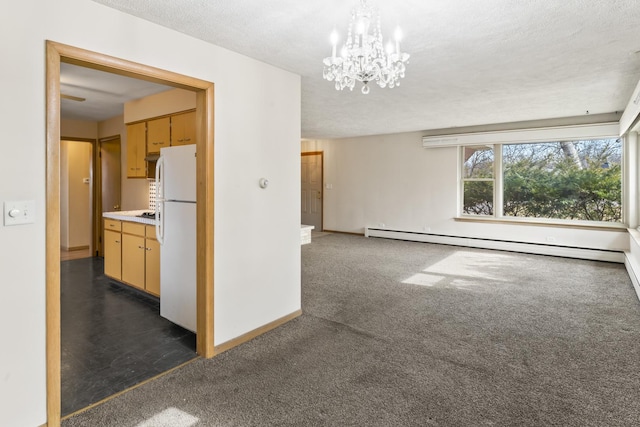 carpeted spare room with a baseboard radiator, a chandelier, and a textured ceiling