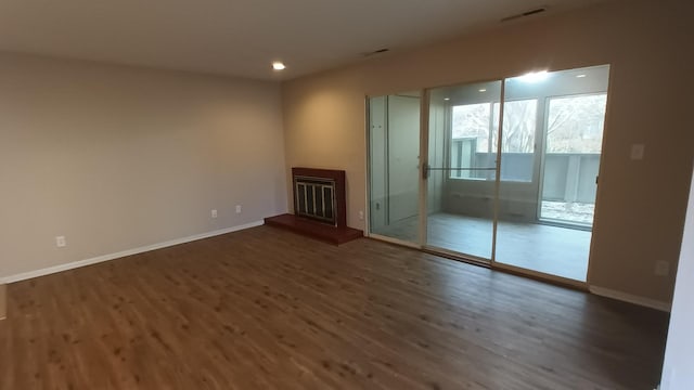 unfurnished living room with dark hardwood / wood-style floors