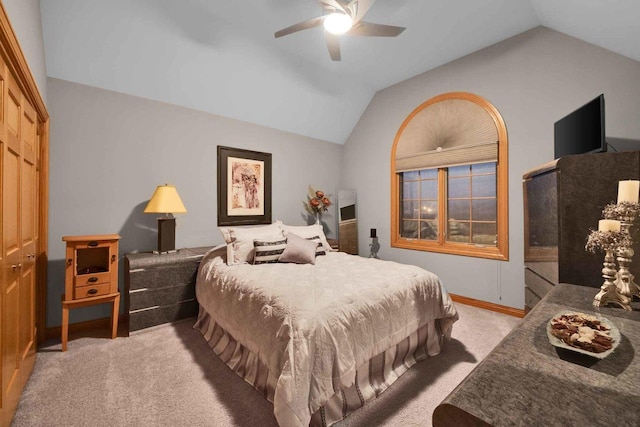 bedroom with lofted ceiling, light colored carpet, and ceiling fan