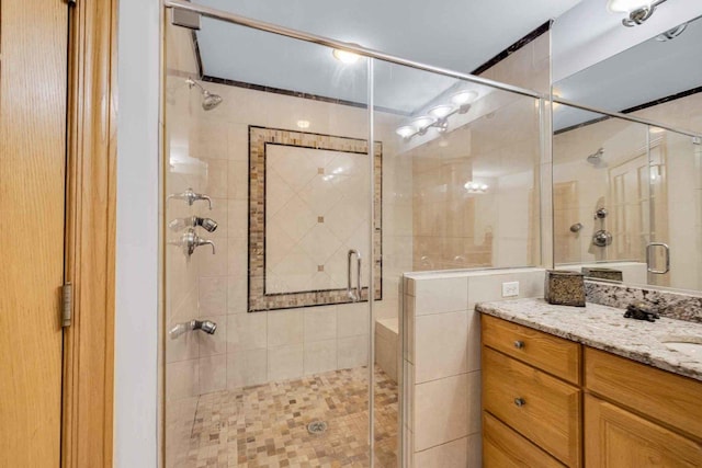 bathroom featuring an enclosed shower and vanity