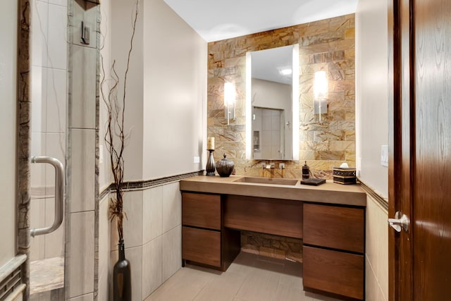 bathroom featuring tile walls, vanity, tile patterned flooring, and walk in shower