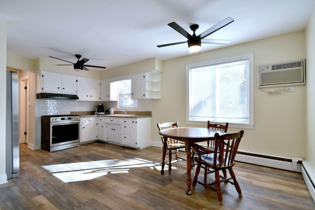 kitchen with white cabinets, decorative backsplash, under cabinet range hood, stainless steel range with electric stovetop, and a wall mounted AC