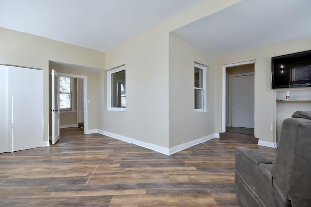 interior space with baseboards and wood finished floors