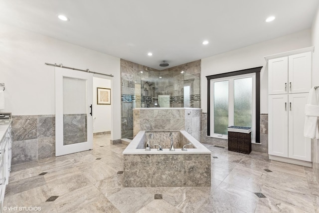 bathroom with tile walls and plus walk in shower