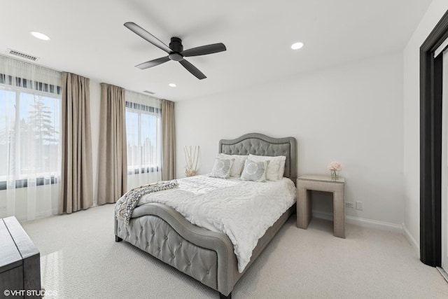 bedroom featuring light carpet and ceiling fan