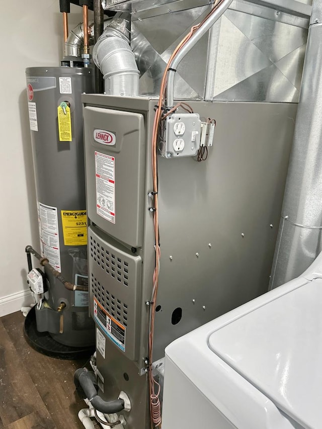 utility room with heating unit and gas water heater