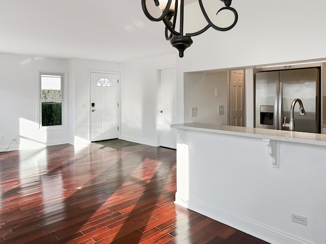 interior space with sink, dark wood-type flooring, and stainless steel refrigerator with ice dispenser