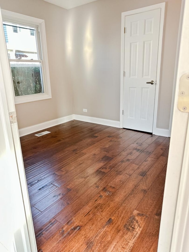 unfurnished room featuring dark hardwood / wood-style flooring