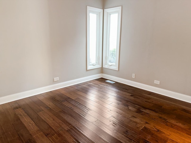 unfurnished room featuring dark hardwood / wood-style flooring