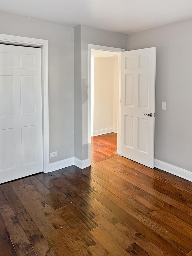 unfurnished bedroom featuring dark wood-type flooring