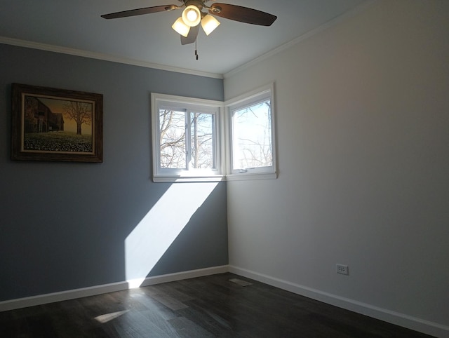 empty room featuring crown molding, dark wood-style floors, a ceiling fan, and baseboards