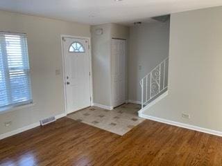 entrance foyer with dark hardwood / wood-style floors