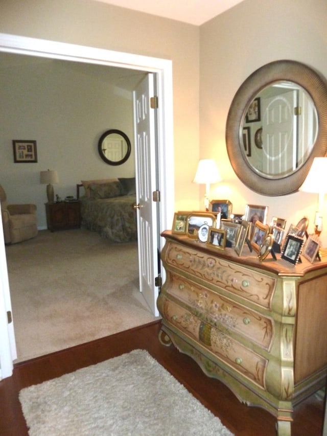 hallway with dark colored carpet