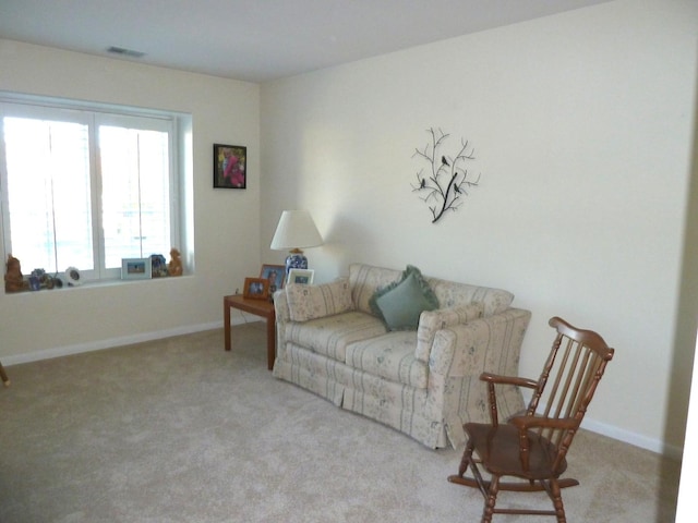 sitting room featuring light colored carpet