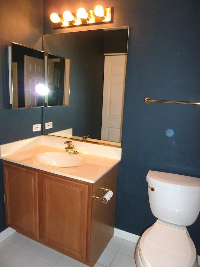 bathroom featuring tile patterned flooring, vanity, and toilet