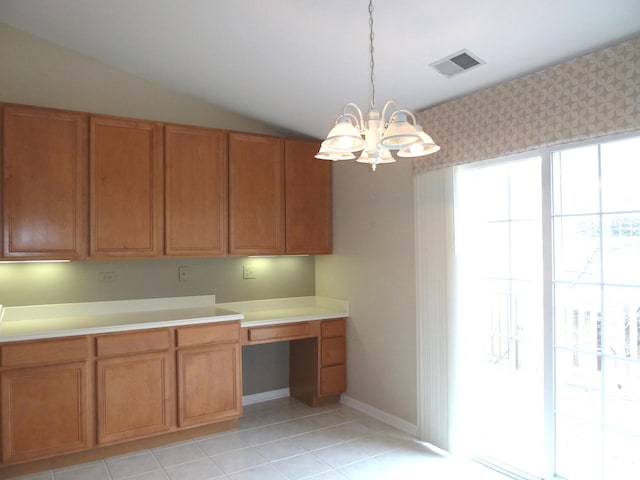 kitchen with lofted ceiling, light tile patterned floors, a chandelier, and decorative light fixtures