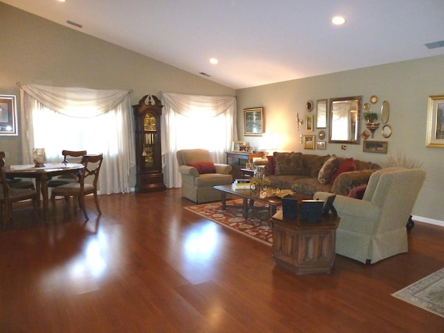 living room with dark wood-type flooring and lofted ceiling