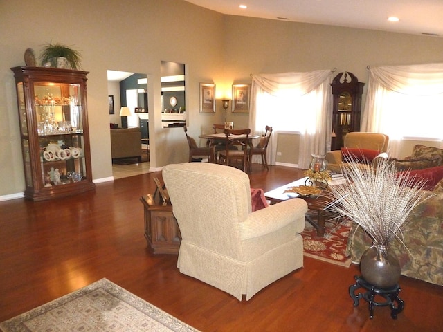 living room featuring lofted ceiling and dark hardwood / wood-style flooring