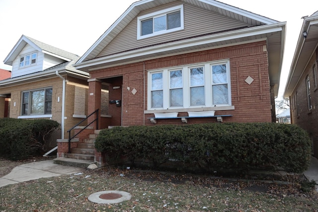 bungalow-style house with brick siding