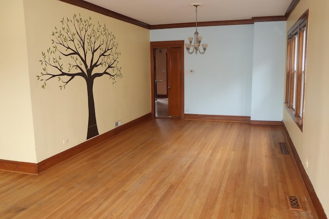 unfurnished room with a chandelier, baseboards, visible vents, and light wood-style flooring