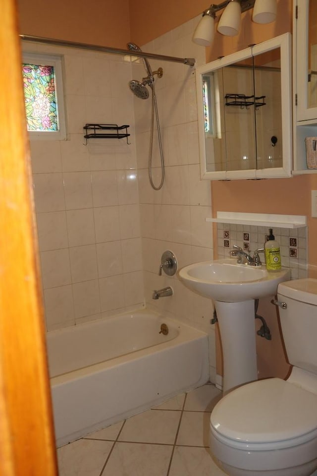 full bath with tile patterned flooring, decorative backsplash, toilet, and tub / shower combination