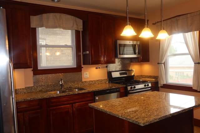 kitchen with a sink, dark brown cabinets, tasteful backsplash, and appliances with stainless steel finishes