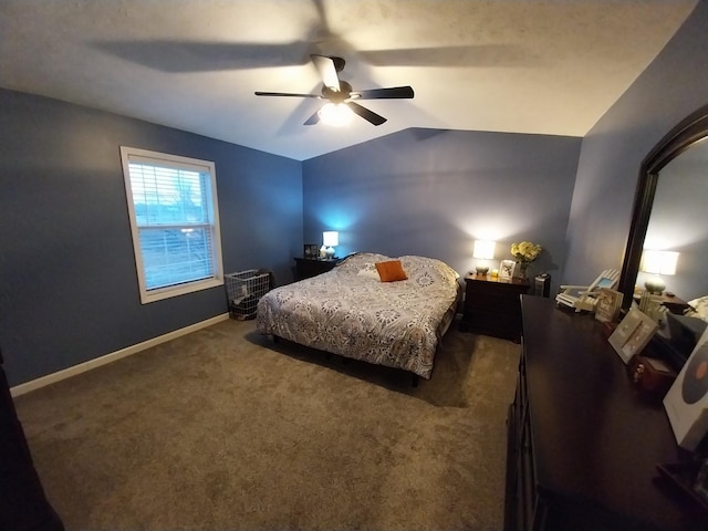 bedroom with lofted ceiling, ceiling fan, and dark colored carpet