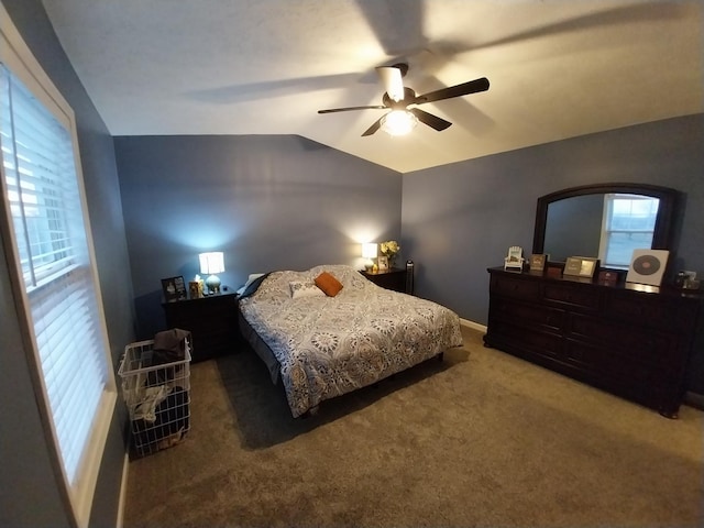 bedroom with ceiling fan, carpet flooring, and vaulted ceiling