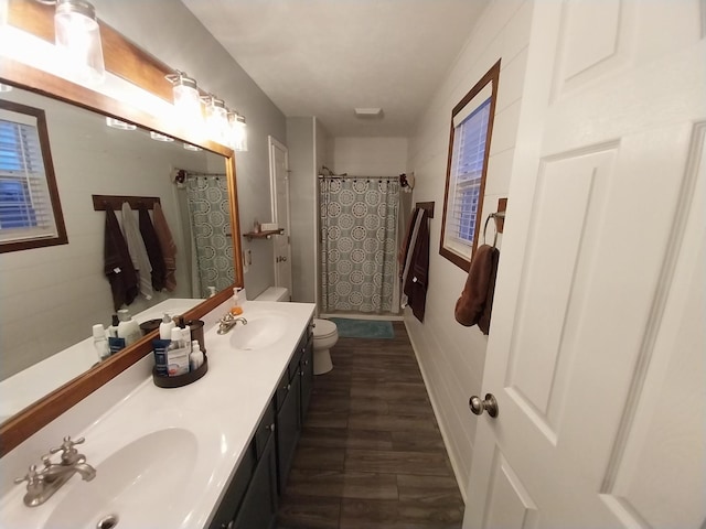 bathroom with vanity, toilet, and curtained shower