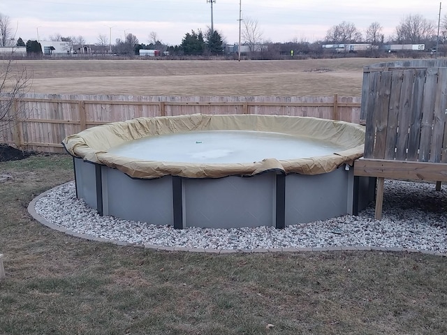 view of yard with a covered pool