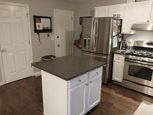 kitchen with stainless steel appliances, a kitchen island, white cabinets, and dark hardwood / wood-style flooring