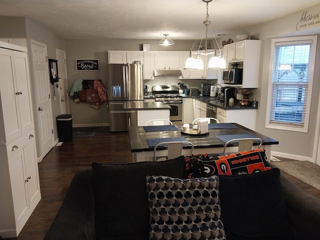 kitchen featuring sink, white cabinetry, a kitchen island, pendant lighting, and stainless steel appliances