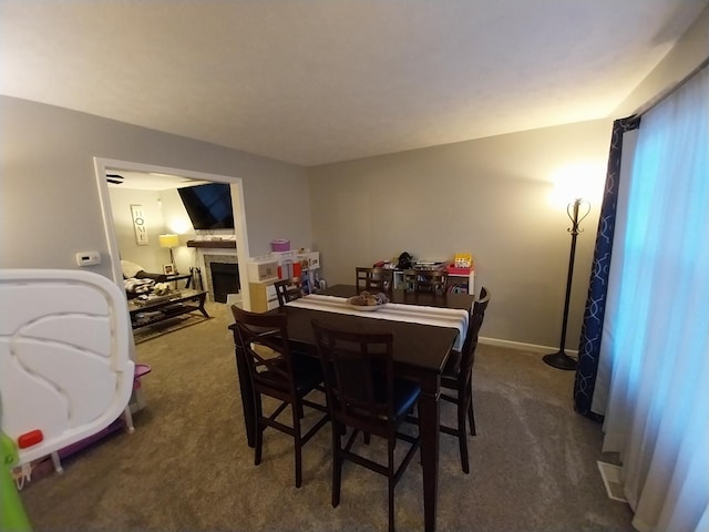 dining room featuring dark carpet