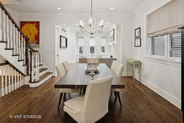 dining space with an inviting chandelier, crown molding, and dark hardwood / wood-style floors