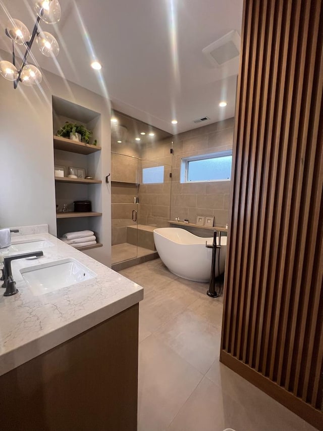 bathroom with tile patterned flooring, vanity, separate shower and tub, and built in shelves