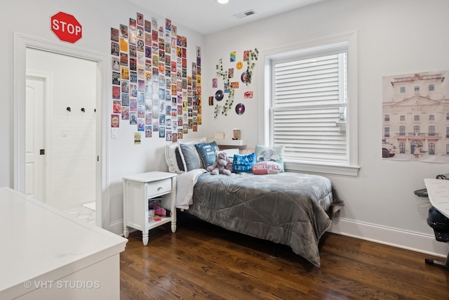 bedroom with dark wood-type flooring