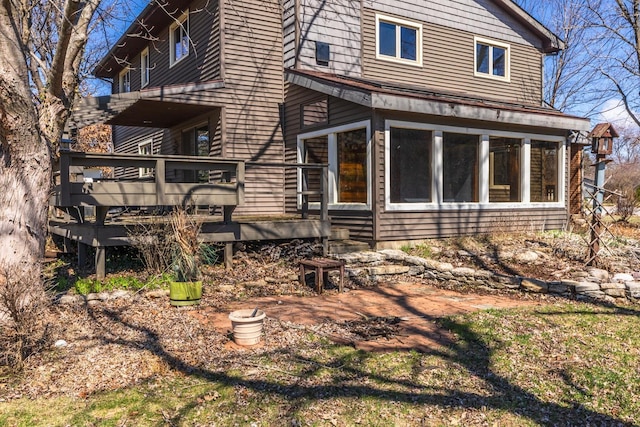 exterior space with a sunroom and a wooden deck