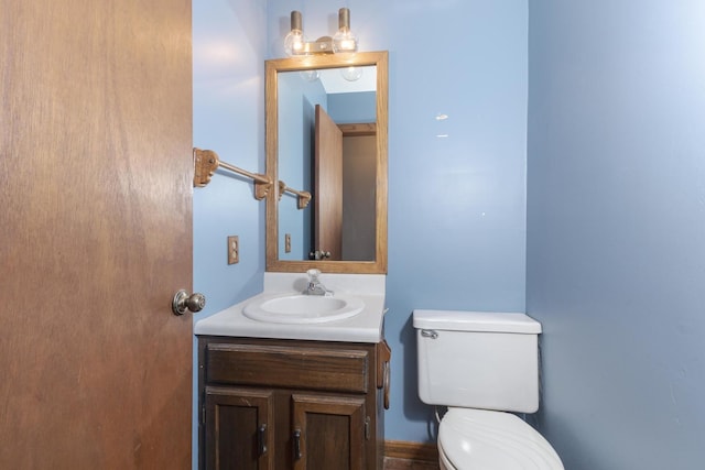 half bath featuring toilet and vanity