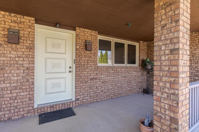 entrance to property with brick siding