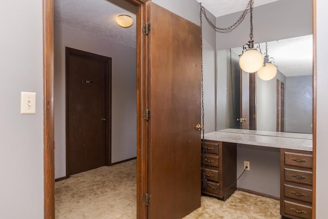 interior space with baseboards and light carpet