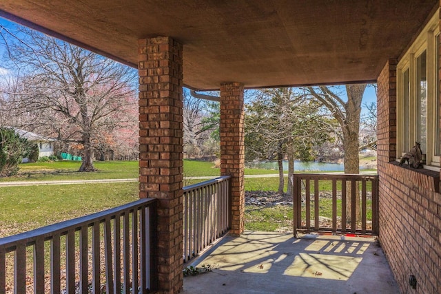 view of patio with a water view and a porch