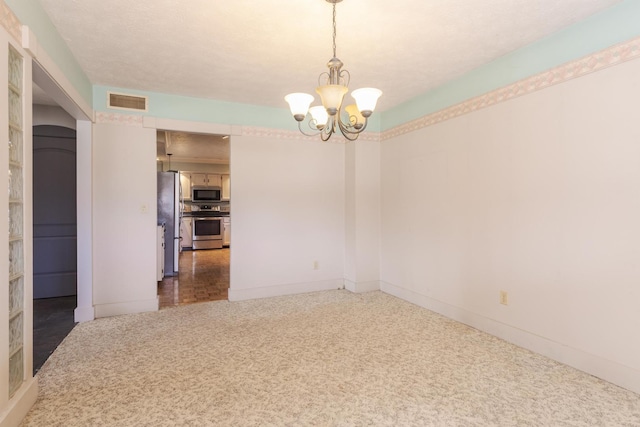 carpeted empty room with baseboards, a chandelier, and visible vents
